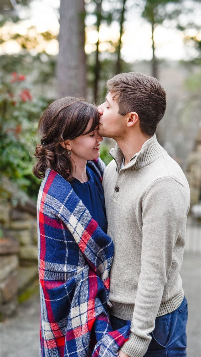 1290x2796 man kissing on woman forehead standing near tree d... - love iPhone Wallpaper