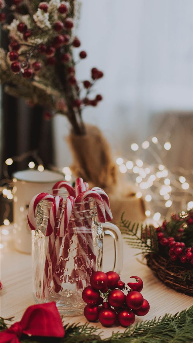 1290x2796 candy cane in clear glass jar near red baubles lig... - food iPhone Wallpaper