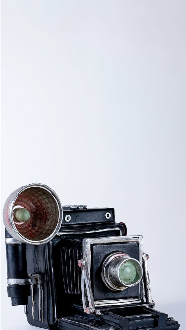 1290x2796 folding camera on white surface - retro iPhone Wallpaper