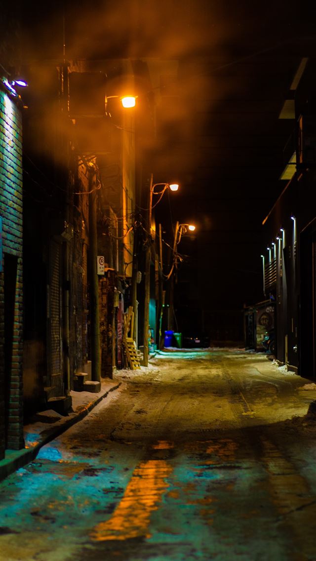1290x2796 empty street between buildings during night time - city iPhone Wallpaper