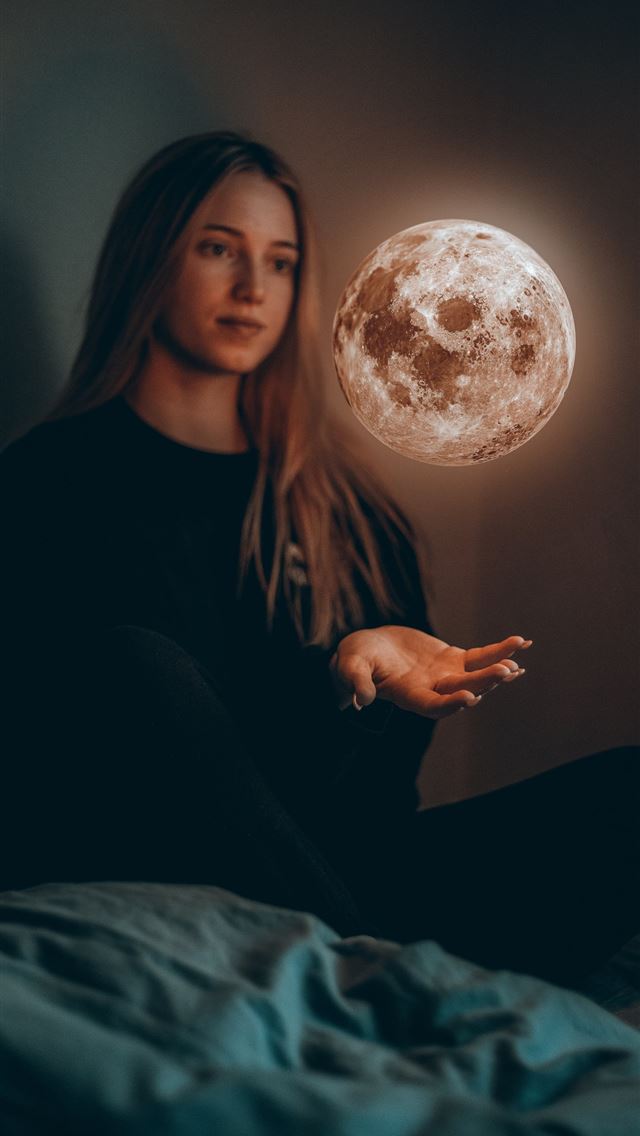 1290x2796 woman in black long sleeve shirt sitting on bed - moon iPhone Wallpaper