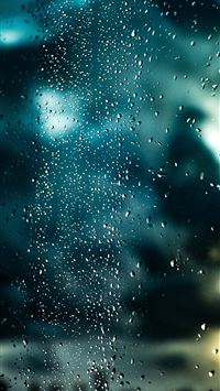 a window with rain drops on the glass wallpaper