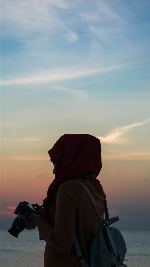 1290x2796 woman holding DSLR camera near body of water - quotes iPhone Wallpaper