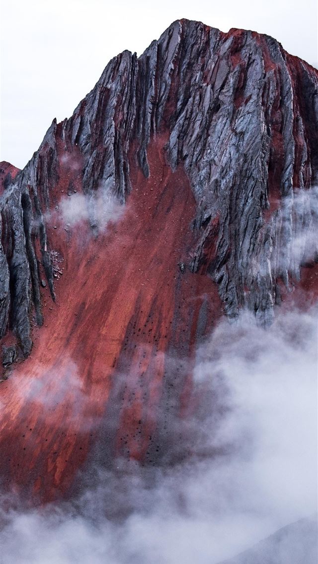 1290x2796 red mountain peeking out behind the clouds cusco p... - nature iPhone Wallpaper