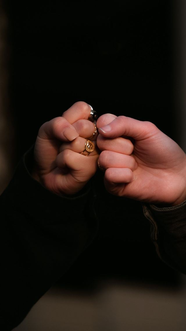 1290x2796 person holding gold ring in dark room - quotes iPhone Wallpaper