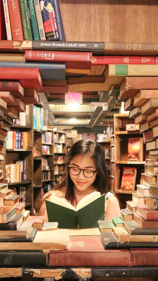 1290x2796 woman in green shirt sitting on books - girl iPhone Wallpaper