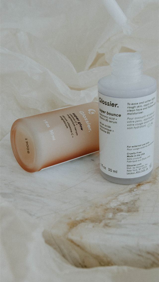 1290x2796 white plastic bottle on white textile - makeup iPhone Wallpaper