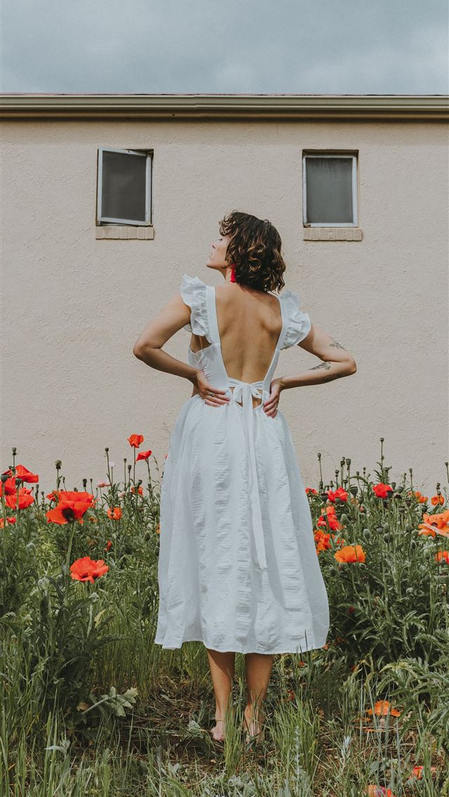 1290x2796 woman in white dress standing on red flower field ... -  iPhone Wallpaper
