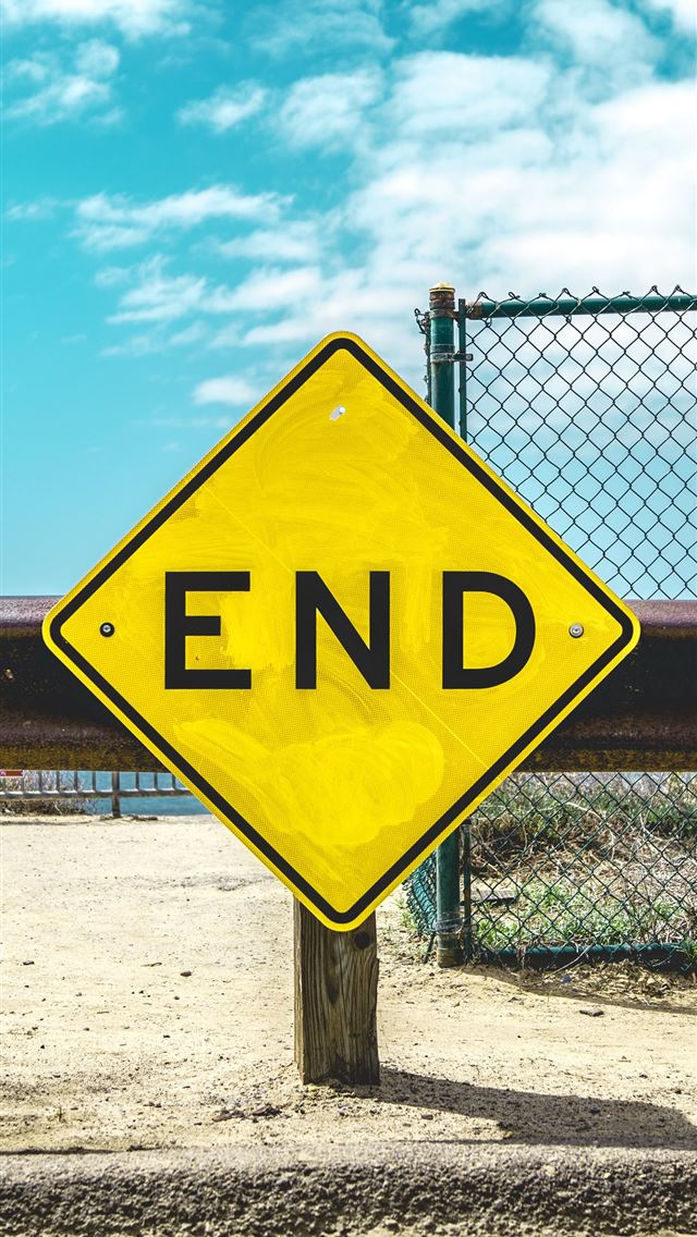 1290x2796 End sign on beige sand - yellow iPhone Wallpaper