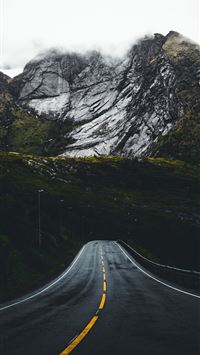 asphalt road leading to mountains wallpaper