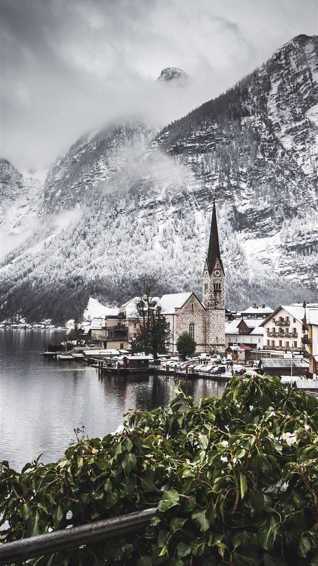 1290x2796 town on the foot of a snow capped mountain - mountains iPhone Wallpaper
