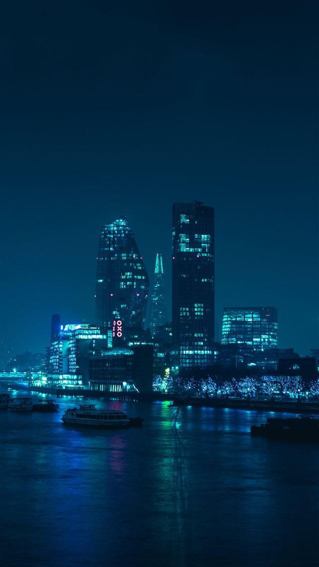 1290x2796 buildings during nighttime - cyan iPhone Wallpaper