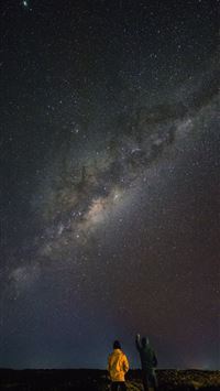 two person standing while watching sky wallpaper