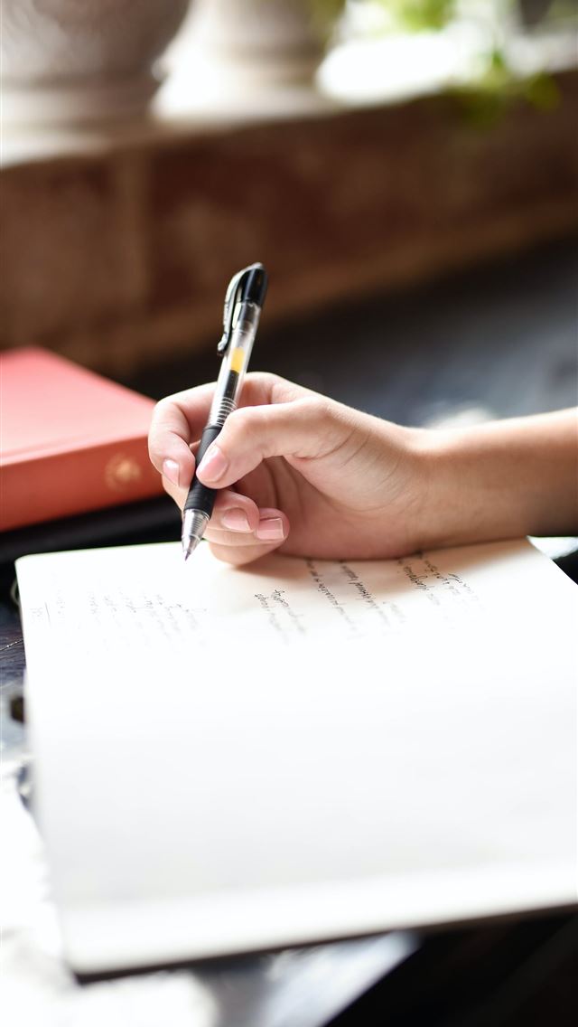 1290x2796 a person writing on a piece of paper with a pen -  iphone 15 Wallpaper