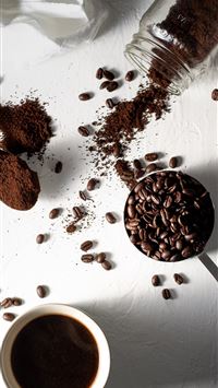 coffee beans on white ceramic mug beside stainless... wallpaper