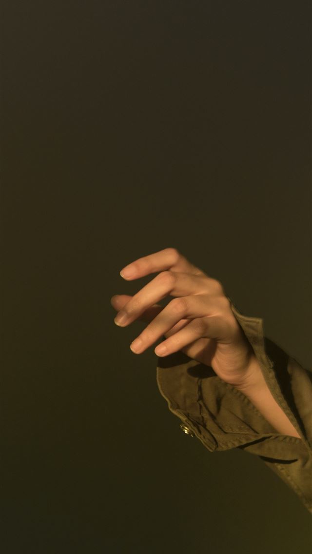 1290x2796 person in brown jacket holding black textile - quotes iPhone Wallpaper