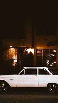 white car parked beside the street wallpaper