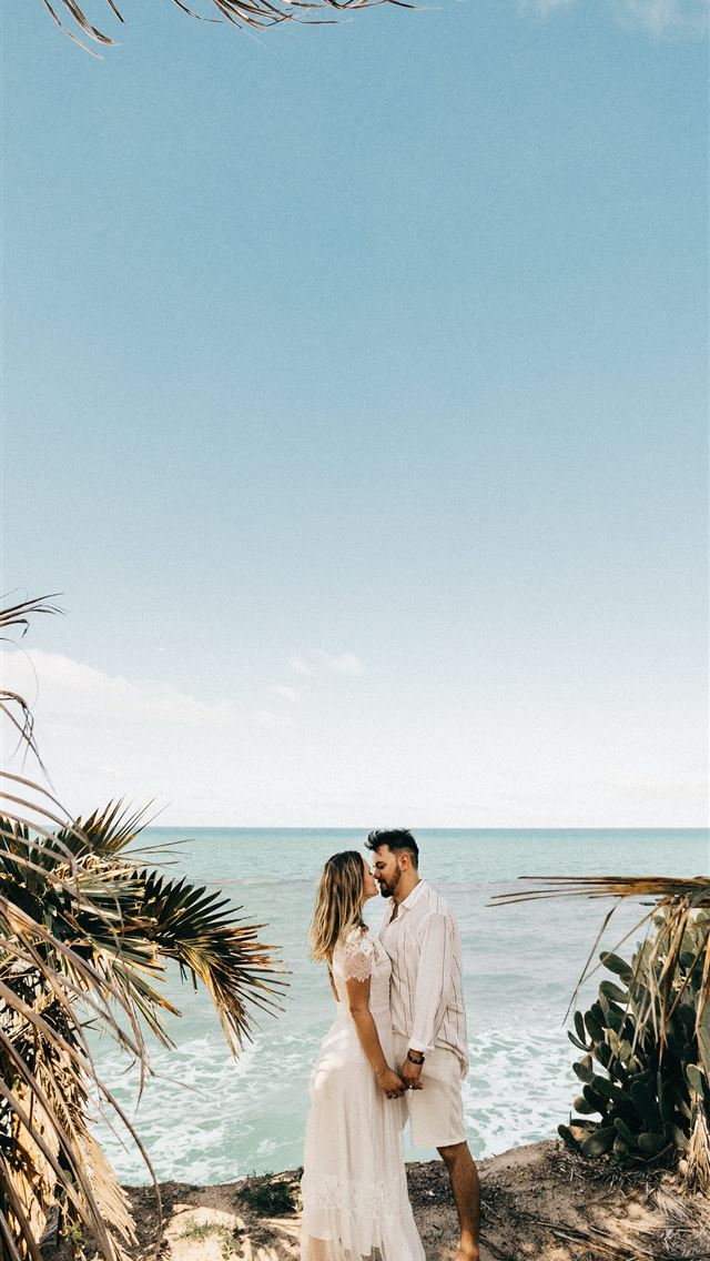 1290x2796 man and woman standing near coconut tree - love iPhone Wallpaper