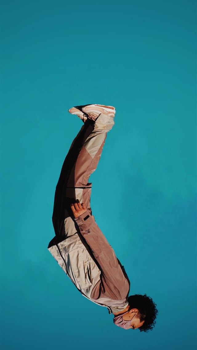 1290x2796 man in brown jacket and black pants -  iphone 15 Wallpaper