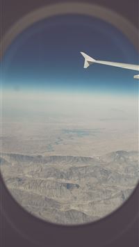 view of mountains from airplane window wallpaper