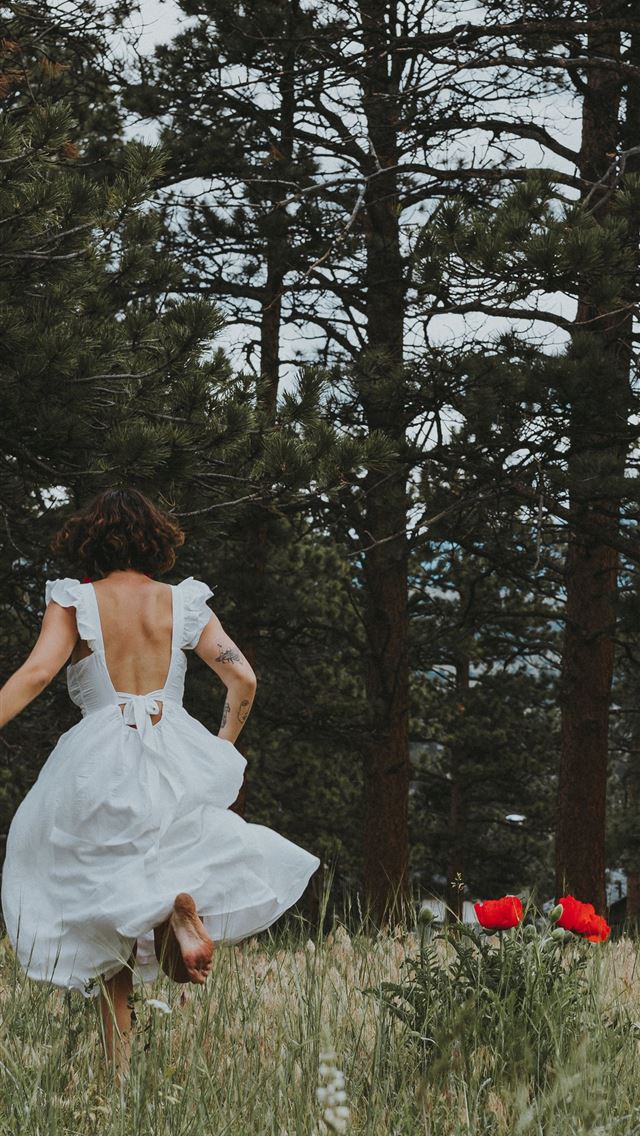 1290x2796 woman in white dress sitting on green grass field ... - illustration iPhone Wallpaper