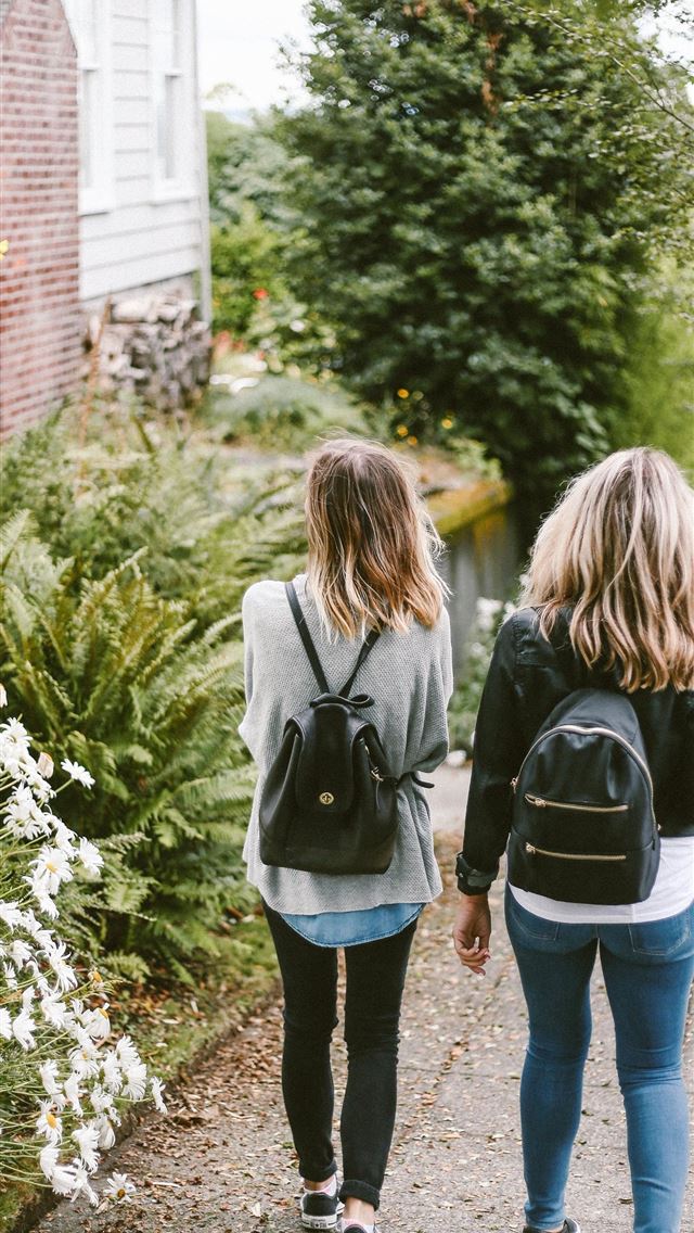 1290x2796 two ladies walking on sidewalk with black backpack... -  iphone 15 Wallpaper