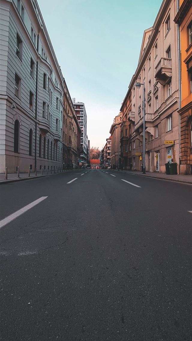 1290x2796 concrete road in middle of buildings during daytim... -  iphone 15 Wallpaper