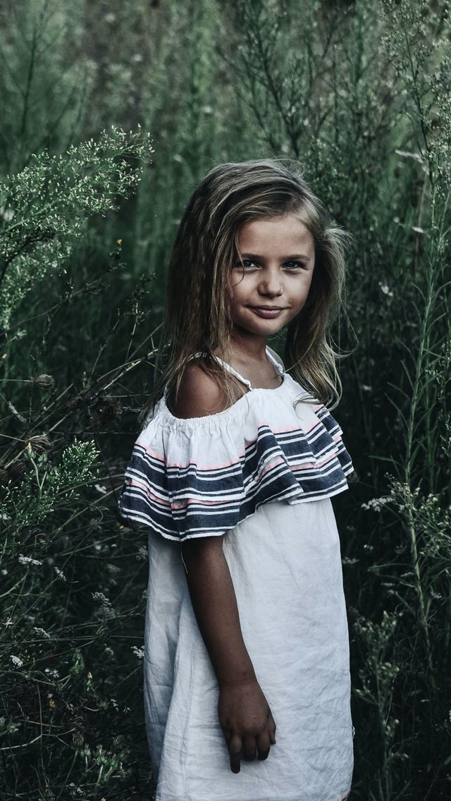 1290x2796 girl standing near tall grasses - girl iPhone Wallpaper
