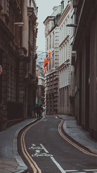 person beside brown building wallpaper