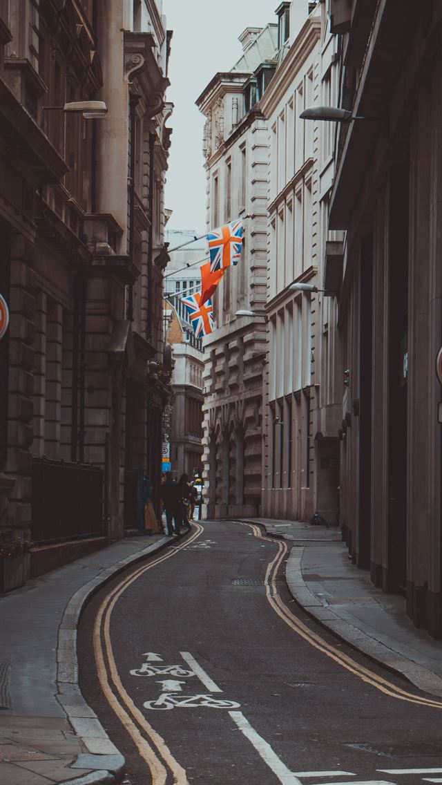1290x2796 person beside brown building - city iPhone Wallpaper