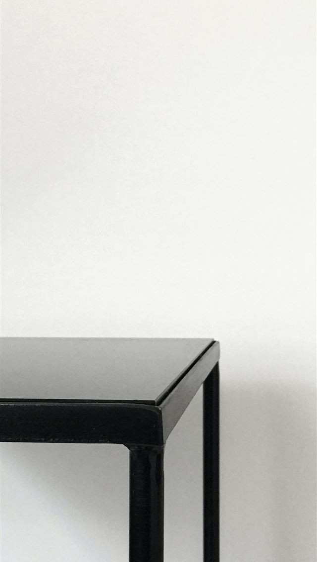 1290x2796 black metal table near white panted wall - simple iPhone Wallpaper