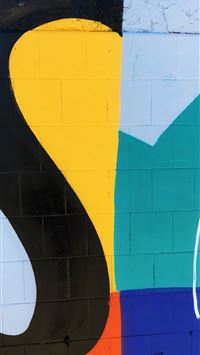 a wall painted with different colors and shapes wallpaper