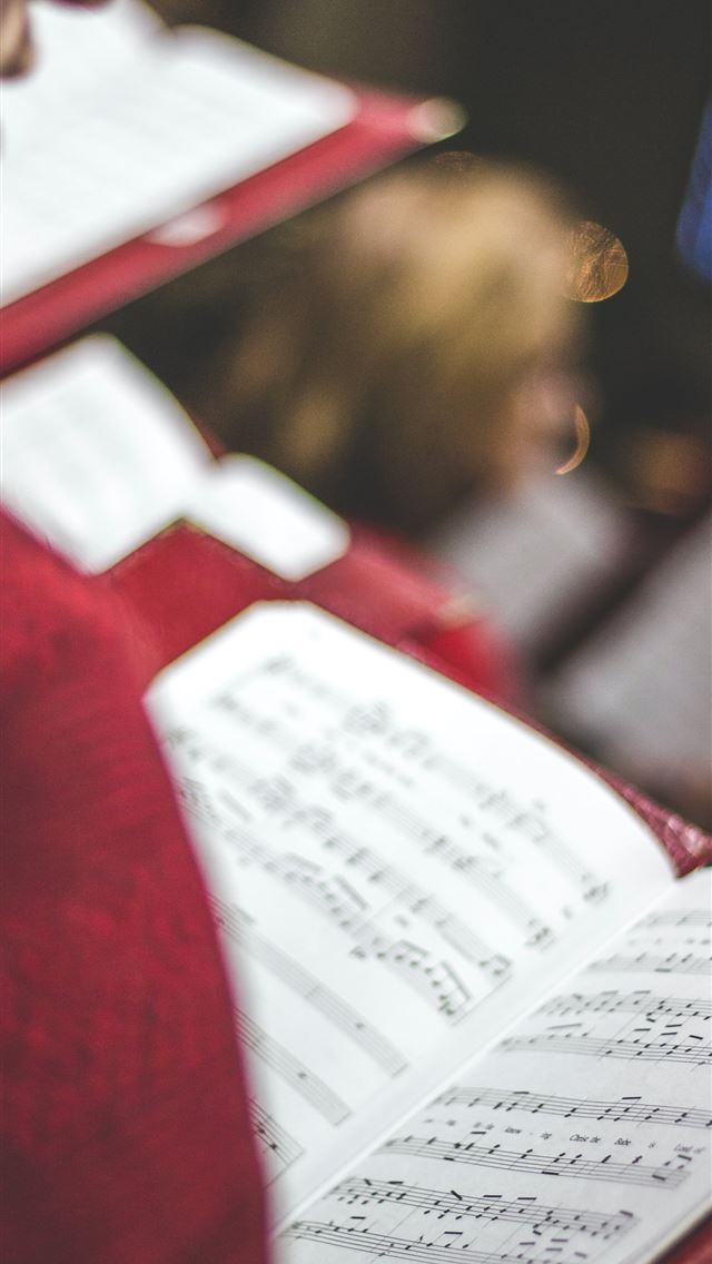 1290x2796 person holding opened song book - holiday iPhone Wallpaper