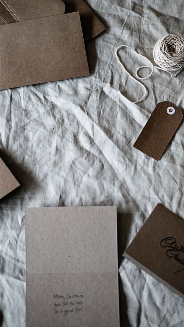 1290x2796 brown envelops on gray textile - holiday iPhone Wallpaper