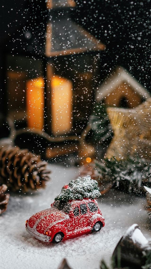 1290x2796 a red toy car sitting on top of a snow covered gro... - car iPhone Wallpaper