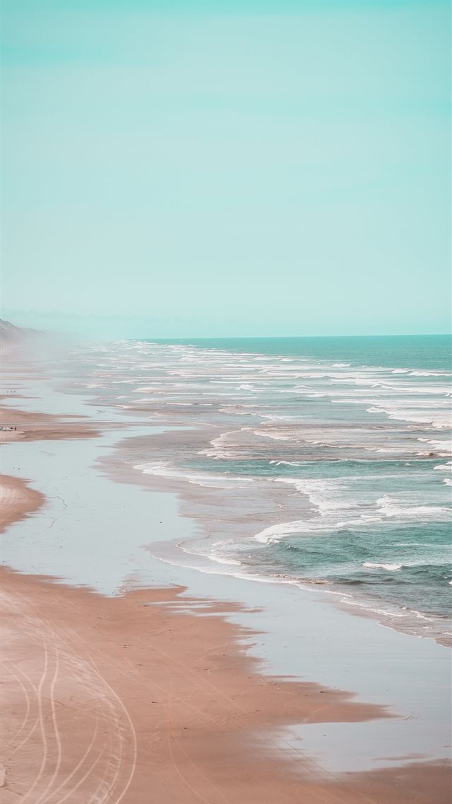 1290x2796 a view of the beach from the top of a hill -  iphone 15 Wallpaper