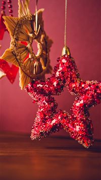 red sequined star handing decor wallpaper