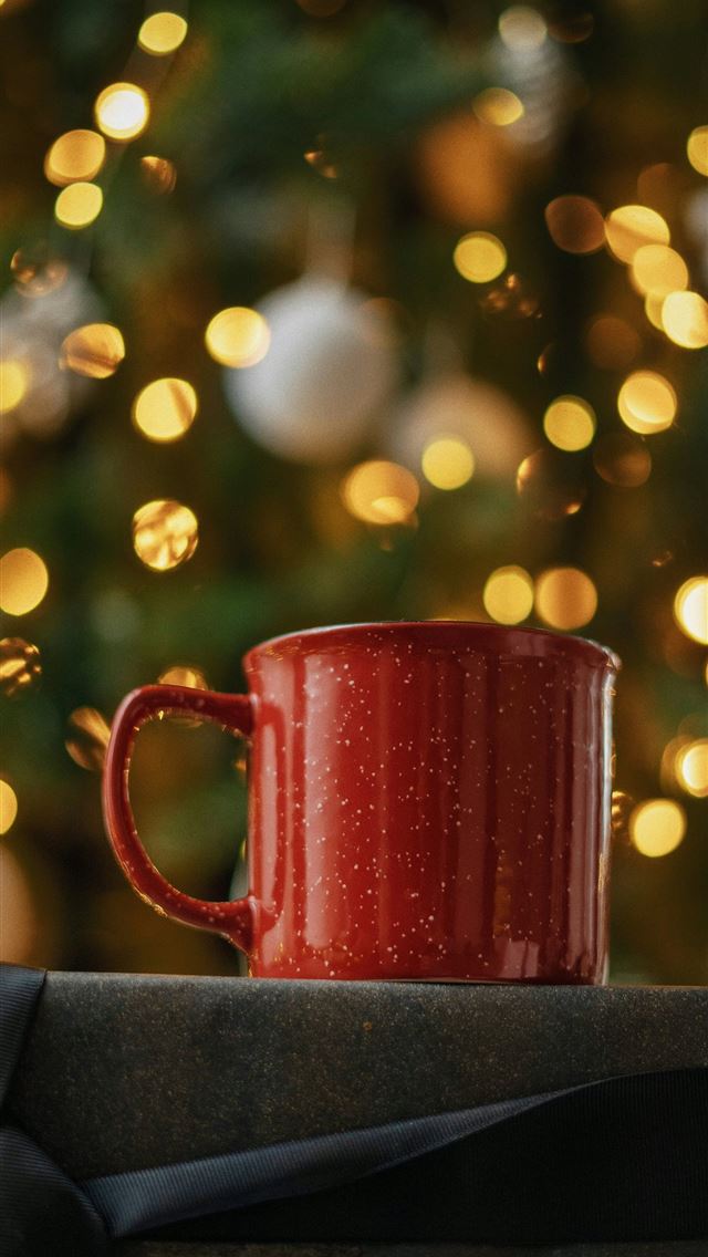 1290x2796 red ceramic mug on black book - christmas tree iPhone Wallpaper