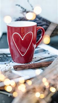red ceramic mug on printing paper wallpaper