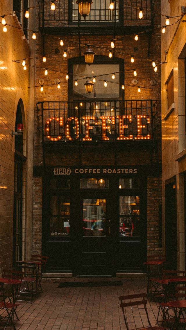 1290x2796 brown and black concrete building - lights iPhone Wallpaper