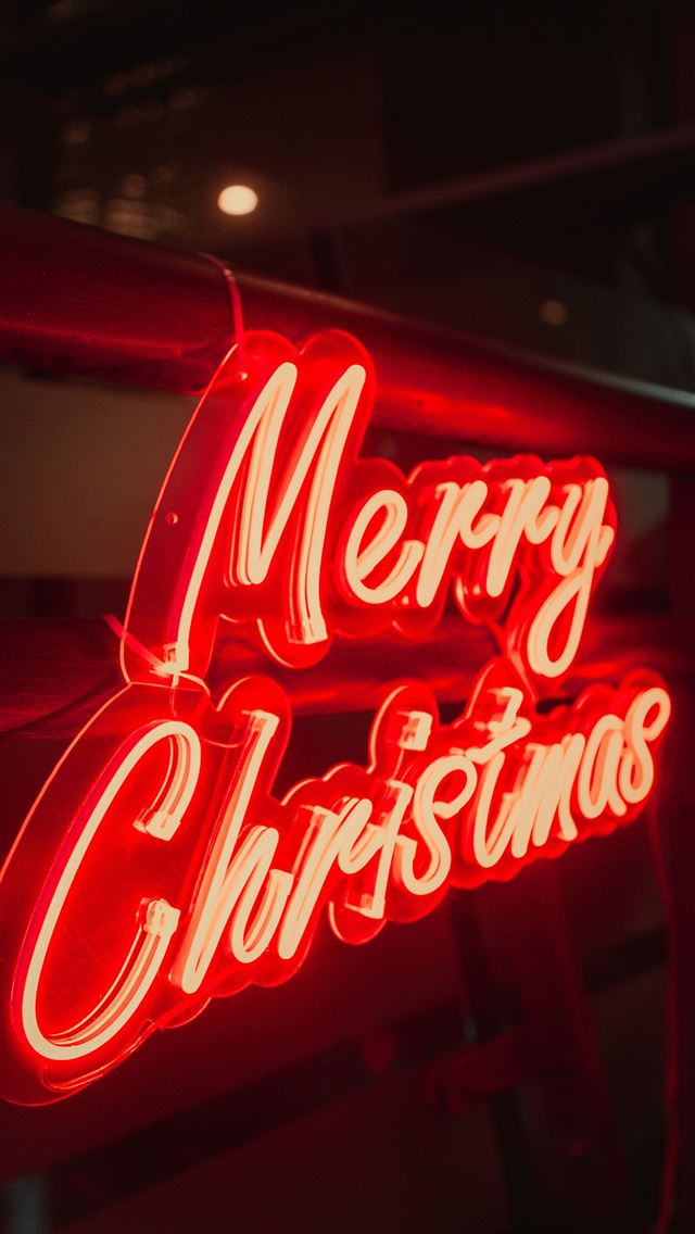 1290x2796 a red merry christmas neon sign hanging from the s... - neon iPhone Wallpaper