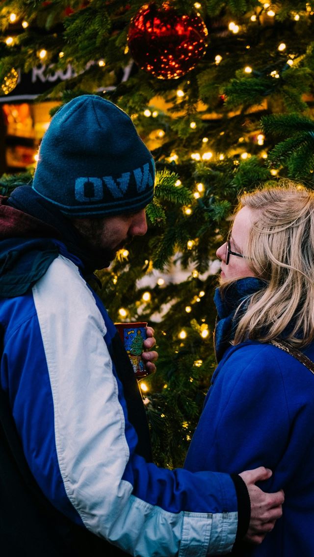 1290x2796 man and woman looking face to face near christmas ... -  iphone 15 Wallpaper