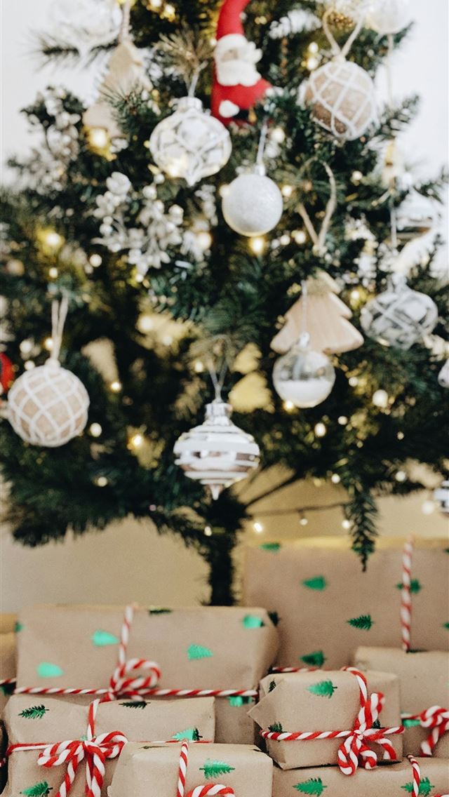 1290x2796 bundle of gifts near Christmas tree - minimalist iPhone Wallpaper