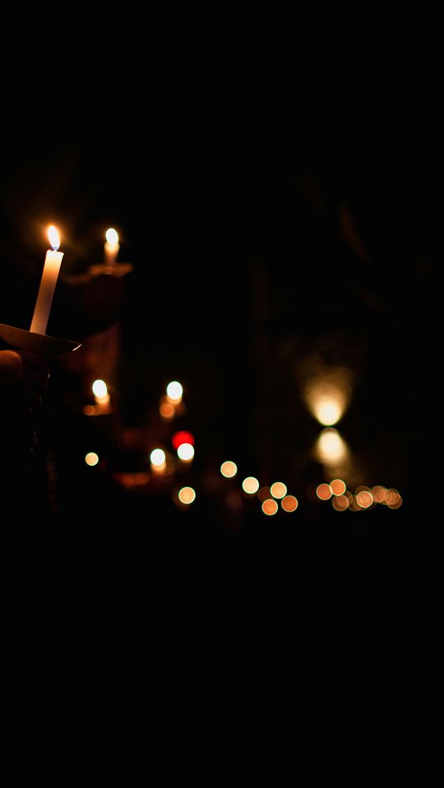 1290x2796 person holding lighted candle during night time - fire iPhone Wallpaper