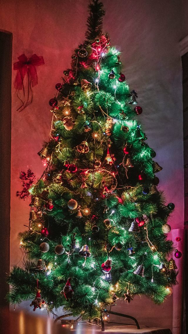 1290x2796 green Christmas tree with decorations and lighted ... -  iphone 15 Wallpaper