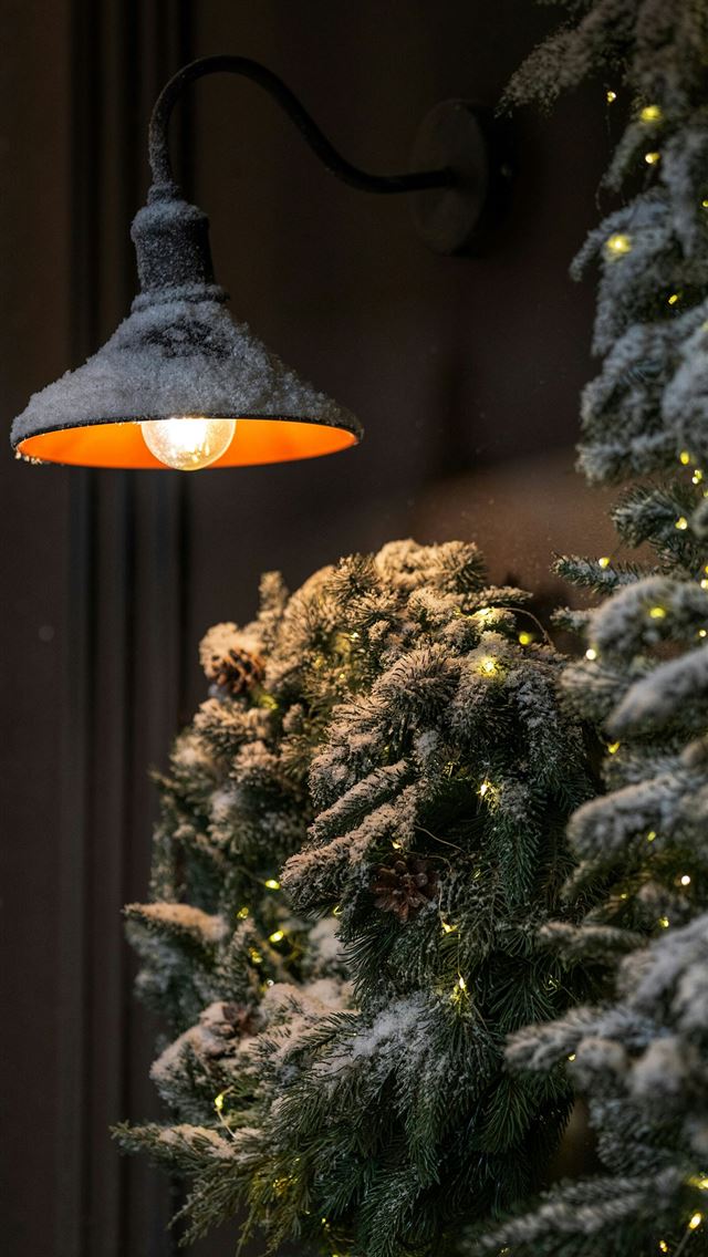 1290x2796 a lamp hanging from the side of a building - christmas iPhone Wallpaper