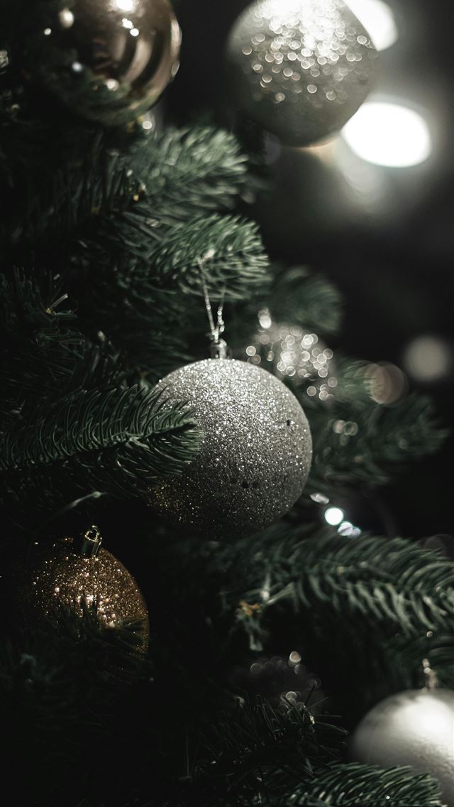 1290x2796 a close up of a christmas tree with ornaments - grey iPhone Wallpaper