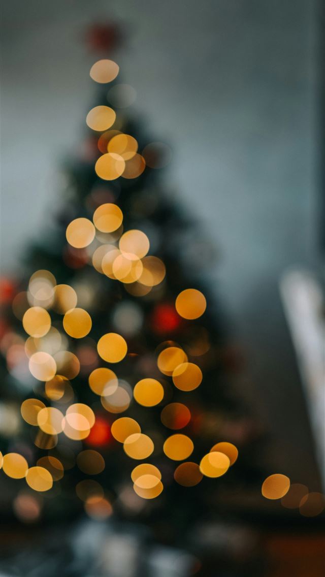1290x2796 a lit christmas tree in a living room - christmas iPhone Wallpaper