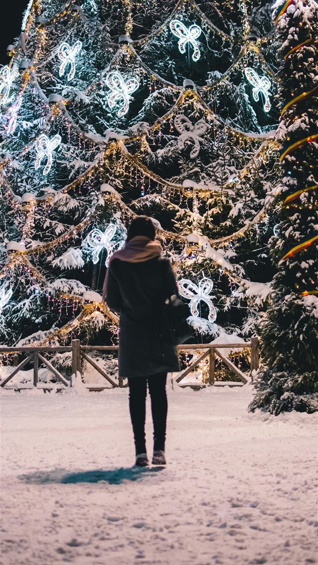 1290x2796 woman wearing brown scarf across Christmas tree - christmas iPhone Wallpaper