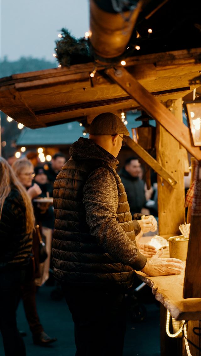 1290x2796 man standing beside food kart - city iPhone Wallpaper